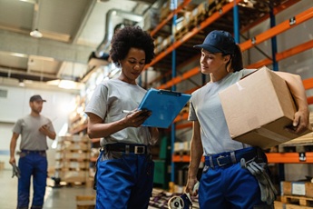 low angle view two female workers reading delivery schedule list while working distribution warehouse 637285 3984